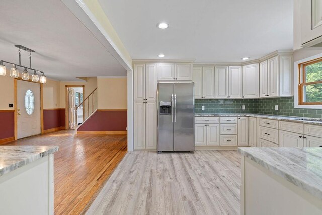 4 W Burda Pl, New City, NY 10956 - kitchen featuring stainless steel fridge with ice dispenser, light wood-style flooring, baseboards, light stone countertops, and backsplash