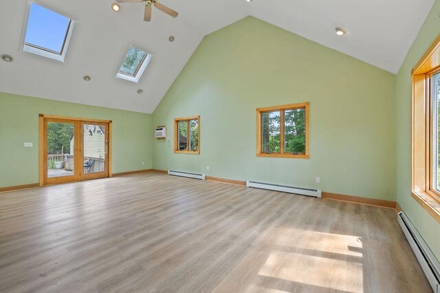 4 W Burda Pl, New City, NY 10956 - unfurnished living room with a baseboard radiator, a baseboard heating unit, high vaulted ceiling, a skylight, and wood finished floors