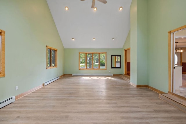 4 W Burda Pl, New City, NY 10956 - unfurnished living room with baseboard heating, high vaulted ceiling, baseboards, wood finished floors, and ceiling fan
