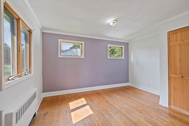 4 W Burda Pl, New City, NY 10956 - unfurnished room featuring radiator, baseboards, light wood-type flooring, ornamental molding, and a textured ceiling