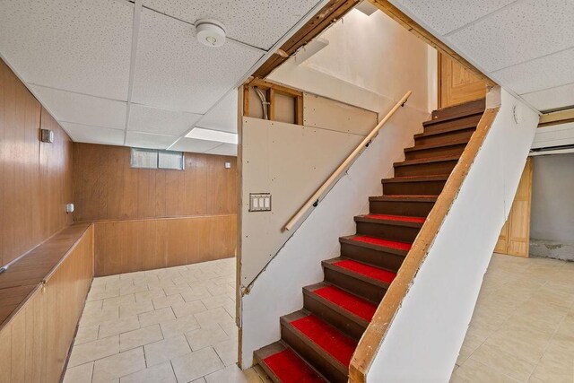 4 W Burda Pl, New City, NY 10956 - staircase with wood walls, a paneled ceiling, and tile patterned floors