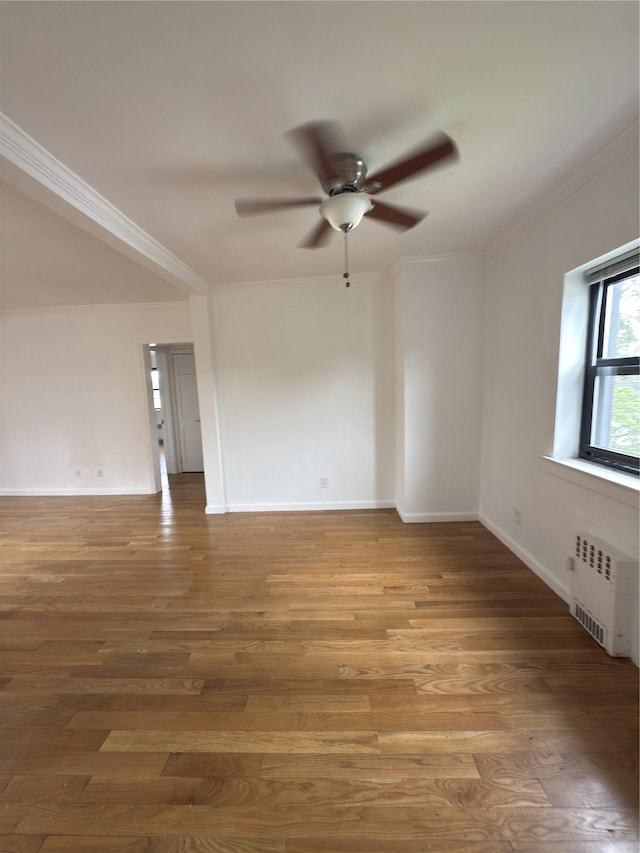 240 Halstead Ave Unit C8, Harrison, NY 10528 - empty room featuring radiator heating unit, ornamental molding, a ceiling fan, baseboards, and wood finished floors