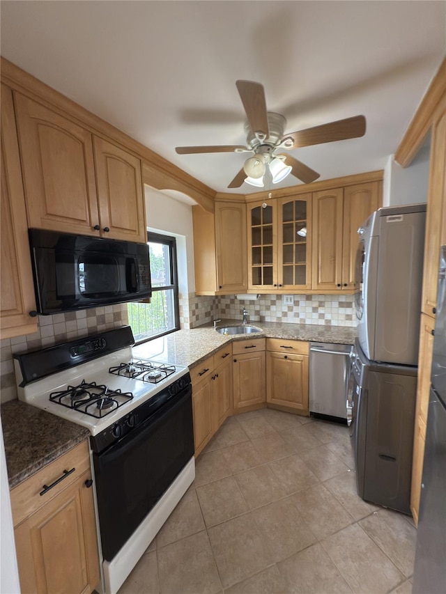 240 Halstead Ave Unit C8, Harrison, NY 10528 - kitchen with range with gas stovetop, black microwave, dishwasher, estacked washer and dryer, and a sink