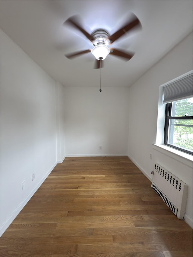 240 Halstead Ave Unit C8, Harrison, NY 10528 - empty room with radiator, a ceiling fan, wood finished floors, and baseboards
