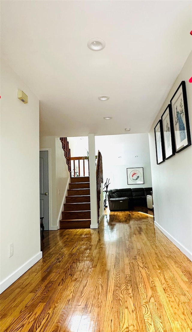 12 Yale Dr, Manhasset, NY 11030 - hallway featuring stairs, wood finished floors, and baseboards