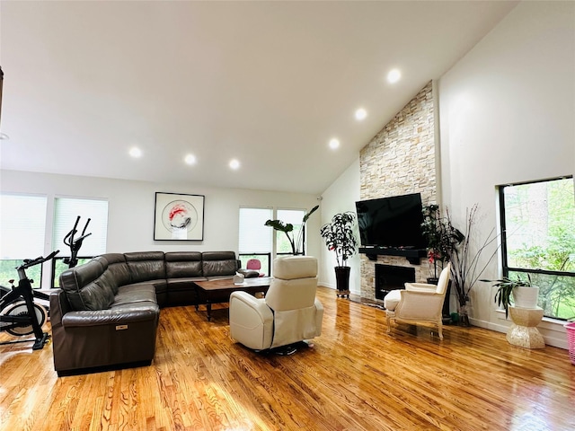 12 Yale Dr, Manhasset, NY 11030 - living area featuring light wood-type flooring, a stone fireplace, recessed lighting, and lofted ceiling