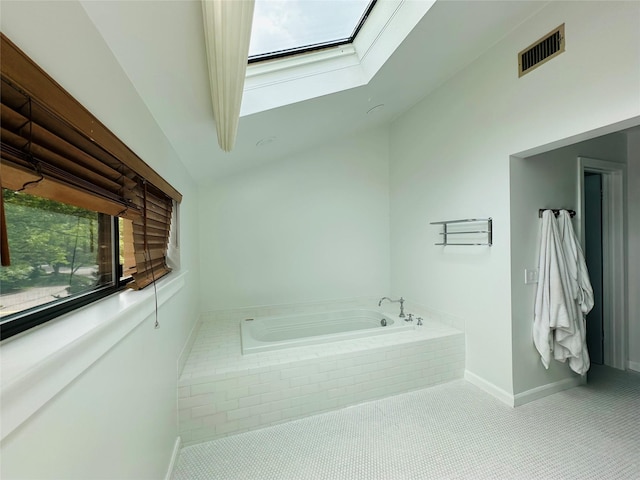 12 Yale Dr, Manhasset, NY 11030 - bathroom featuring a garden tub, a skylight, baseboards, and lofted ceiling