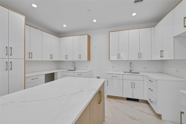 244 Blauvelt Rd Unit 213, Monsey, NY 10952 - kitchen with light stone countertops, recessed lighting, light marble finish flooring, and white cabinets
