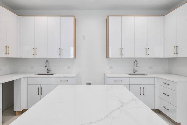 244 Blauvelt Rd Unit 213, Monsey, NY 10952 - kitchen featuring light stone countertops and white cabinetry