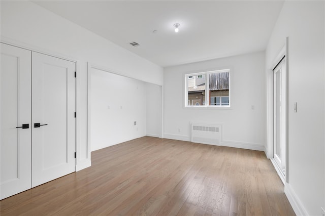 244 Blauvelt Rd Unit 213, Monsey, NY 10952 - unfurnished bedroom with radiator, multiple closets, and light wood-type flooring