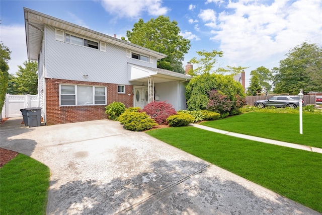 32 Cedar St, Lindenhurst, NY 11757 - view of front of house with brick siding, a chimney, and concrete driveway