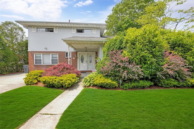 32 Cedar St, Lindenhurst, NY 11757 - view of front of property with brick siding and a front lawn