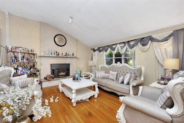 32 Cedar St, Lindenhurst, NY 11757 - living room with lofted ceiling, wood finished floors, and a fireplace