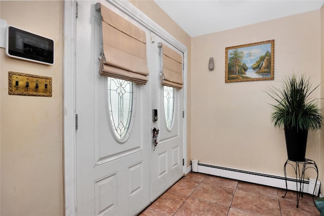 32 Cedar St, Lindenhurst, NY 11757 - entrance foyer featuring a baseboard heating unit, light tile patterned floors, and baseboards