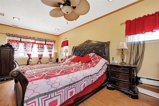 32 Cedar St, Lindenhurst, NY 11757 - bedroom featuring wood finished floors, multiple windows, crown molding, recessed lighting, and baseboard heating