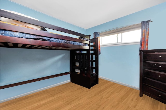 32 Cedar St, Lindenhurst, NY 11757 - unfurnished bedroom featuring wood finished floors and baseboards