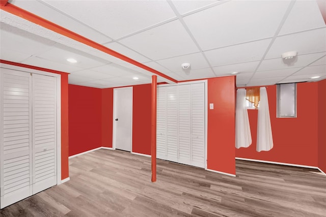 32 Cedar St, Lindenhurst, NY 11757 - finished basement with a drop ceiling, wood finished floors, baseboards, and recessed lighting