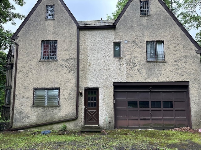 2 Rochelle Rd, Larchmont, NY 10538 - rear view of house featuring stucco siding and a garage