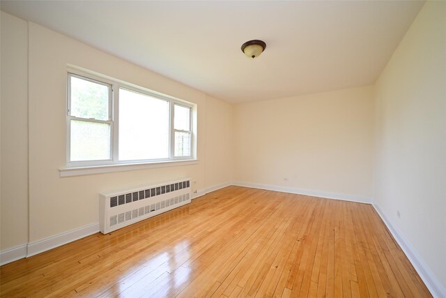 20-21 Parsons Blvd, Whitestone, NY 11357 - empty room with radiator and light wood finished floors