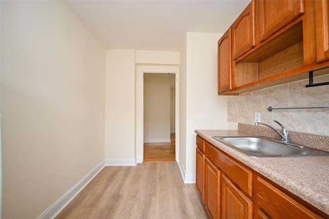 20-21 Parsons Blvd, Whitestone, NY 11357 - kitchen with light wood finished floors, backsplash, brown cabinets, light countertops, and open shelves