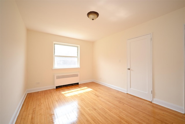 20-21 Parsons Blvd, Whitestone, NY 11357 - spare room with radiator heating unit and light wood-style floors
