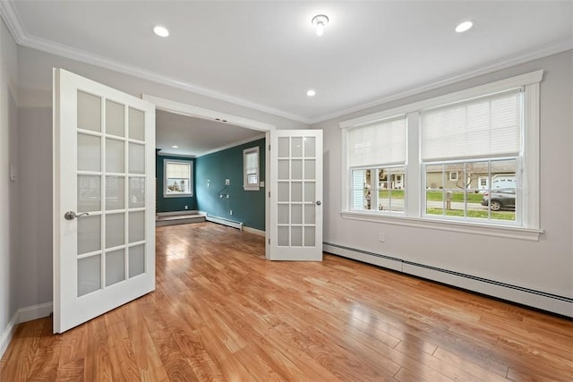 513 3rd St, Newburgh, NY 12550 - spare room with french doors, baseboard heating, ornamental molding, light wood-style flooring, and plenty of natural light