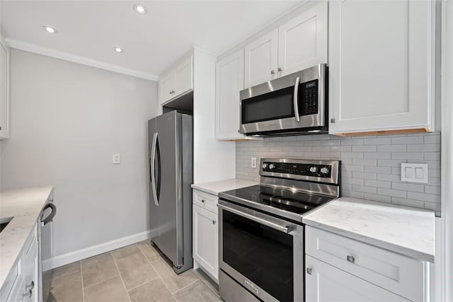 513 3rd St, Newburgh, NY 12550 - kitchen featuring stainless steel appliances, decorative backsplash, white cabinets, light stone countertops, and recessed lighting