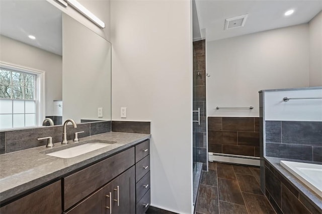 513 3rd St, Newburgh, NY 12550 - full bathroom featuring a baseboard radiator, vanity, a shower stall, a bath, and recessed lighting