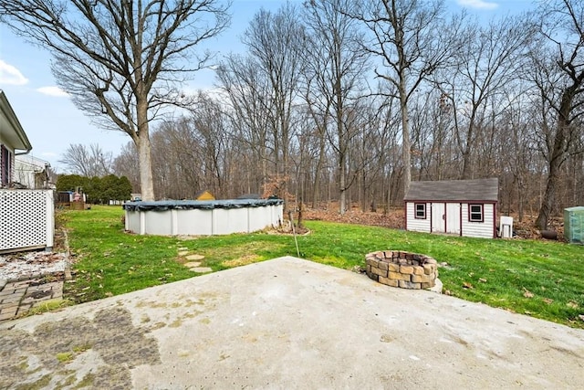 513 3rd St, Newburgh, NY 12550 - view of patio / terrace featuring an outdoor fire pit, a covered pool, and a storage shed