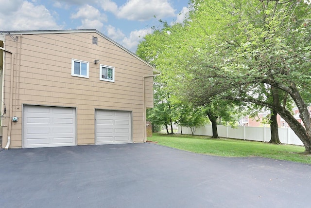 11 Claremont Ln, Suffern, NY 10901 - view of side of home with asphalt driveway and a garage