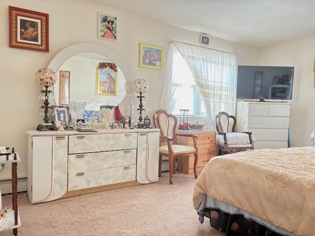 148 Bch 97th St, Rockaway Beach, NY 11693 - bedroom with light colored carpet and baseboard heating
