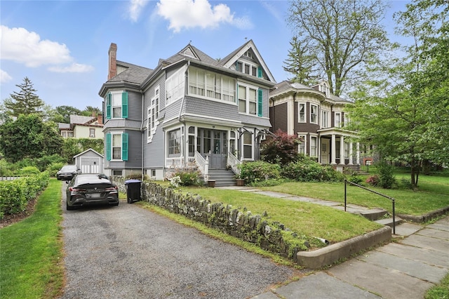 25 Garfield Pl, Poughkeepsie, NY 12601 - victorian house with a chimney and a front lawn