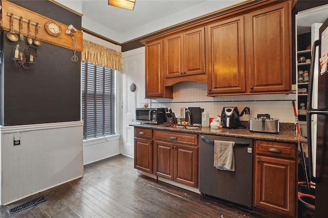 25 Garfield Pl, Poughkeepsie, NY 12601 - kitchen with appliances with stainless steel finishes, backsplash, dark wood-style flooring, brown cabinets, and wainscoting
