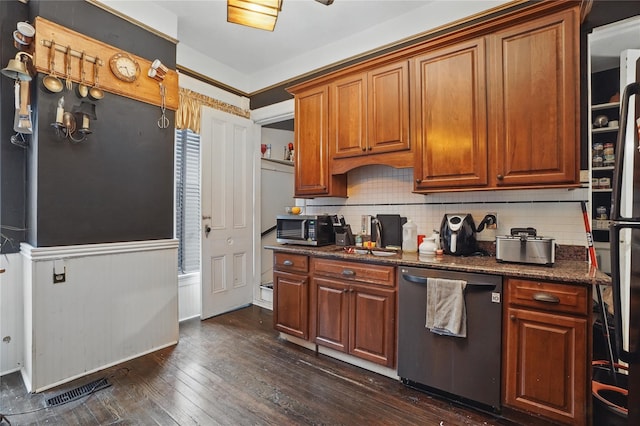 25 Garfield Pl, Poughkeepsie, NY 12601 - kitchen with appliances with stainless steel finishes, dark wood-style flooring, decorative backsplash, brown cabinets, and wainscoting