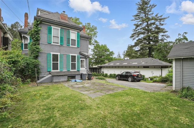 25 Garfield Pl, Poughkeepsie, NY 12601 - rear view of house featuring a chimney and a lawn