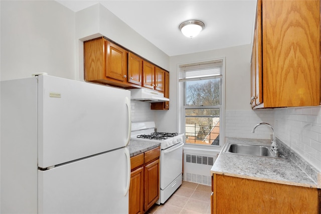 83-36 Beverly Rd Unit 5A, Kew Gardens, NY 11415 - kitchen featuring white appliances, radiator, a sink, under cabinet range hood, and brown cabinets