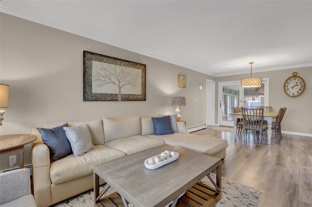738 Craft Ave, Franklin Square, NY 11010 - living area featuring crown molding, light wood finished floors, and a baseboard heating unit