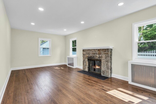 46 Beatrice Ct, Hempstead, NY 11550 - unfurnished living room featuring plenty of natural light, radiator heating unit, wood finished floors, and recessed lighting