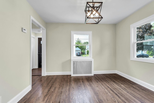 46 Beatrice Ct, Hempstead, NY 11550 - unfurnished dining area featuring a chandelier, plenty of natural light, wood finished floors, and baseboards