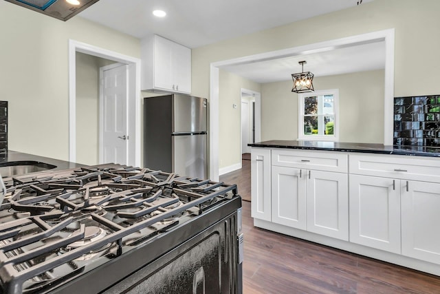 46 Beatrice Ct, Hempstead, NY 11550 - kitchen with freestanding refrigerator, gas range oven, dark wood finished floors, white cabinets, and recessed lighting