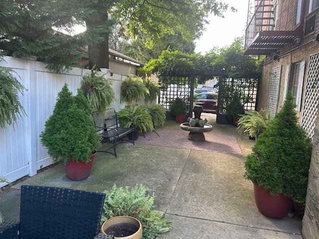 504 Merrick Rd Unit 4E, Lynbrook, NY 11563 - fenced backyard with a patio