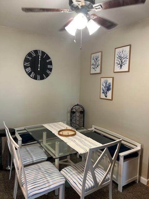 504 Merrick Rd Unit 4E, Lynbrook, NY 11563 - dining space featuring ceiling fan and dark colored carpet