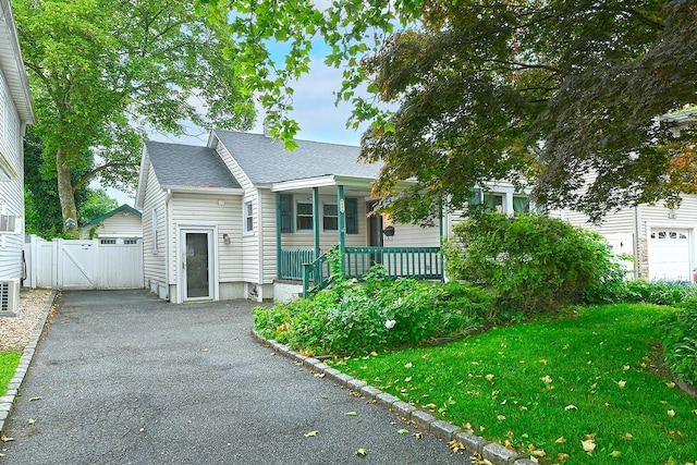 426 Lakeview Rd, Bellmore, NY 11710 - view of front of house featuring a gate, covered porch, and roof with shingles