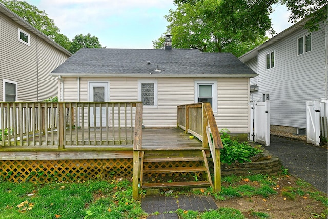 426 Lakeview Rd, Bellmore, NY 11710 - back of house with a chimney, a wooden deck, and a shingled roof