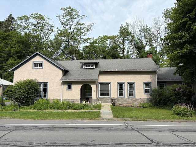 13 Rockland Rd, Roscoe, NY 12776 - view of front of house featuring stone siding, a shingled roof, stucco siding, and a chimney