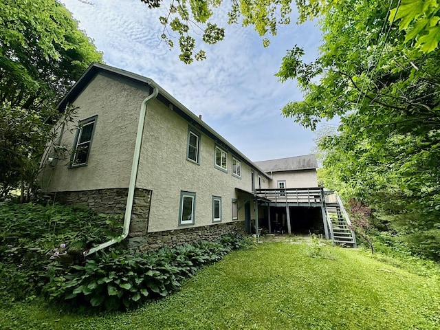 13 Rockland Rd, Roscoe, NY 12776 - rear view of house featuring stairs, stucco siding, a deck, stone siding, and a lawn