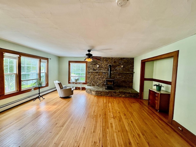13 Rockland Rd, Roscoe, NY 12776 - living area featuring a wood stove, wood finished floors, and ceiling fan