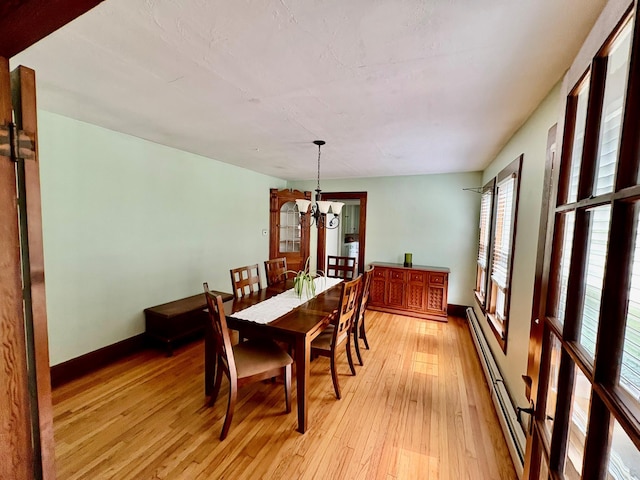 13 Rockland Rd, Roscoe, NY 12776 - dining room featuring a baseboard heating unit, light wood-style flooring, and a chandelier