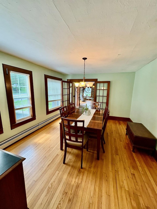 13 Rockland Rd, Roscoe, NY 12776 - dining room with baseboard heating, light wood-type flooring, and a chandelier
