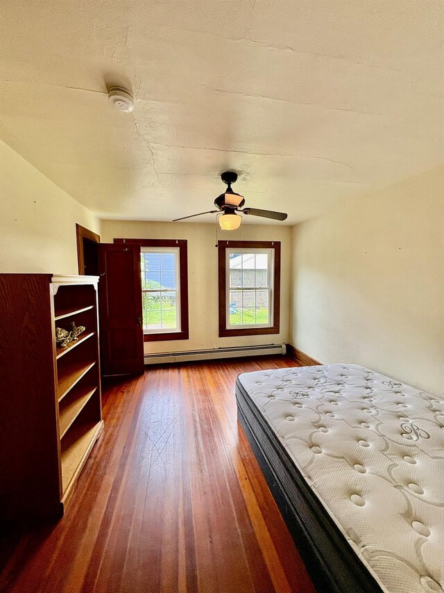 13 Rockland Rd, Roscoe, NY 12776 - bedroom with a baseboard radiator, wood finished floors, and ceiling fan